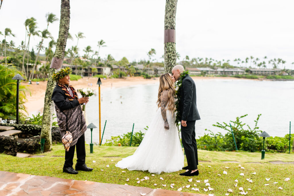 Bride and groom sharing a kiss during their Maui wedding ceremo