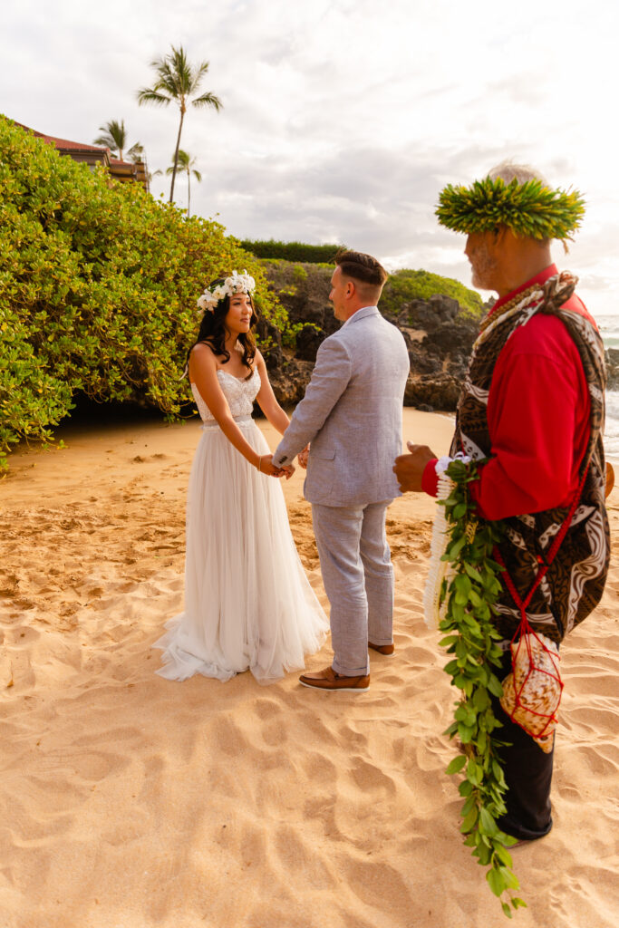 Bride and groom sharing an emotional gaze while holding hands at a Maui elopement