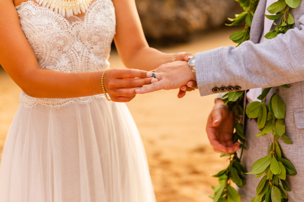 Bride and groom exchanging rings during their elopement in Maui