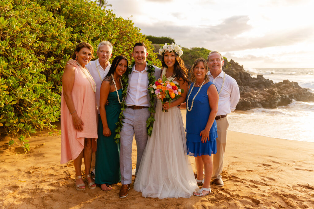 Newly married couple with family following a beach elopement in Maui
