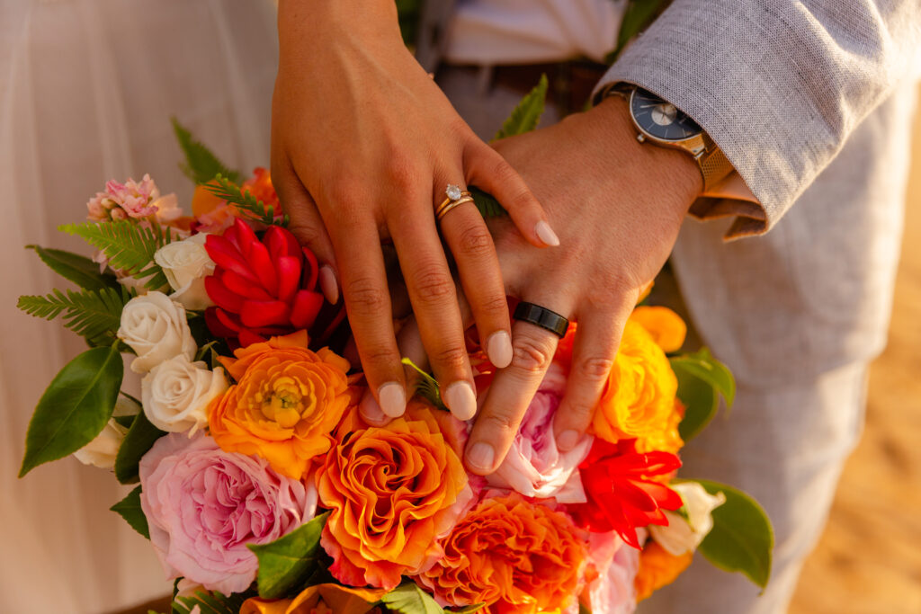 Close up of hands with wedding rings during a Maui beach elopement
