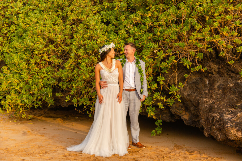 Intimate moment after a Maui elopement as the groom holds the bride while they share a quiet look
