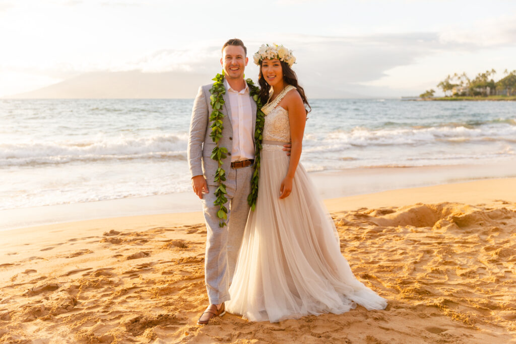 Newly married couple celebrating their Maui elopement by the ocean