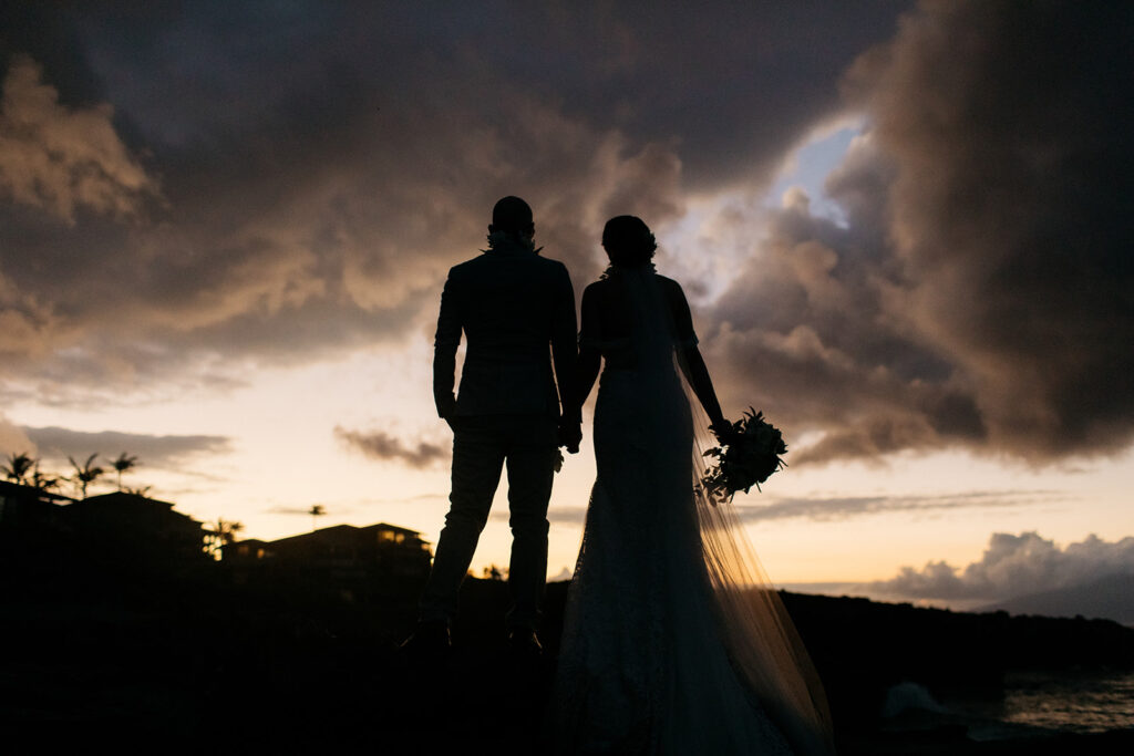Silhouette of a newly married couple on a Maui beach at sunset
