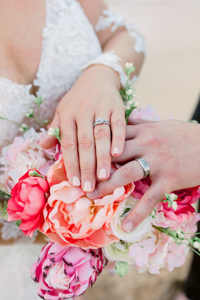 Bride and groom showing their wedding rings