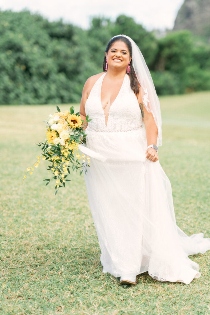Bride in a minimalist crepe wedding dress looking out at the ocean during her Maui wedding day.

