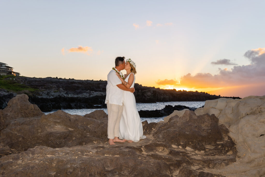 Ironwood Beach Kapalua, sunset kiss on rocky shoreline in Maui

