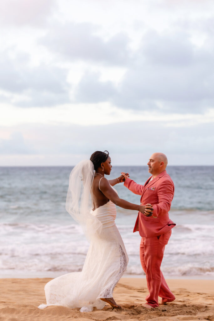 Bride and groom dancing together on the sand at their Maui beach elopement