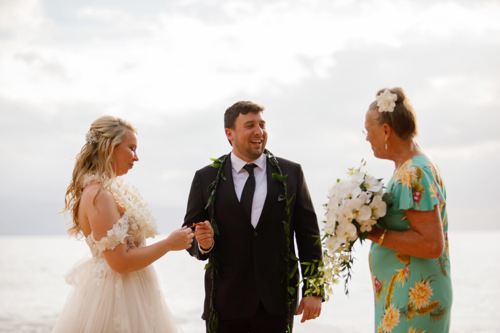 Couple laughing during intimate Maui wedding ceremony on the beach