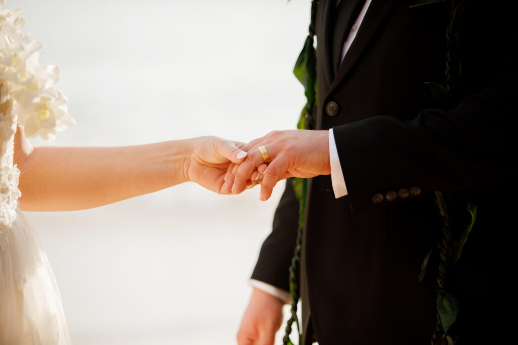 Couple holding hands during Maui beach wedding ceremony in Hawaii