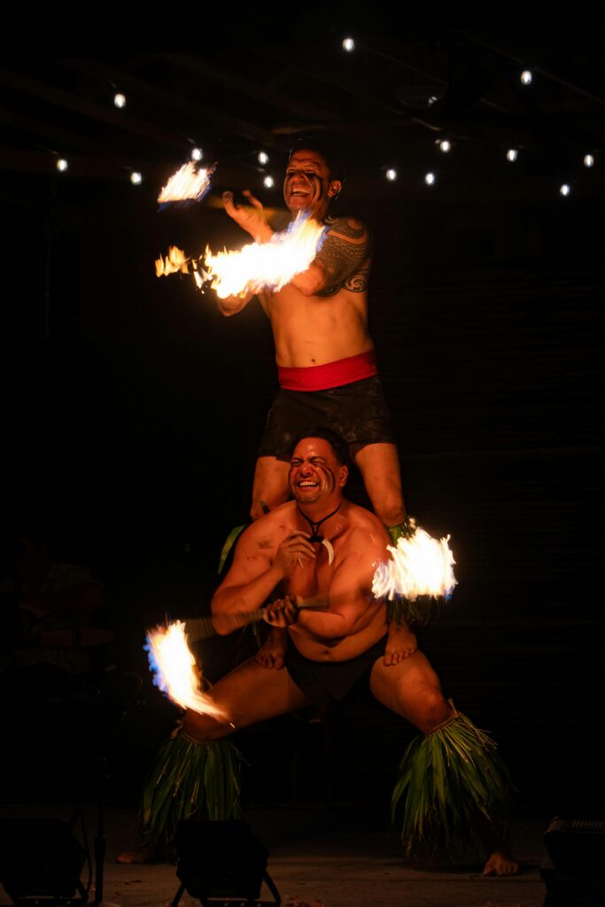 Traditional fire dancers performing during a Maui luau at night