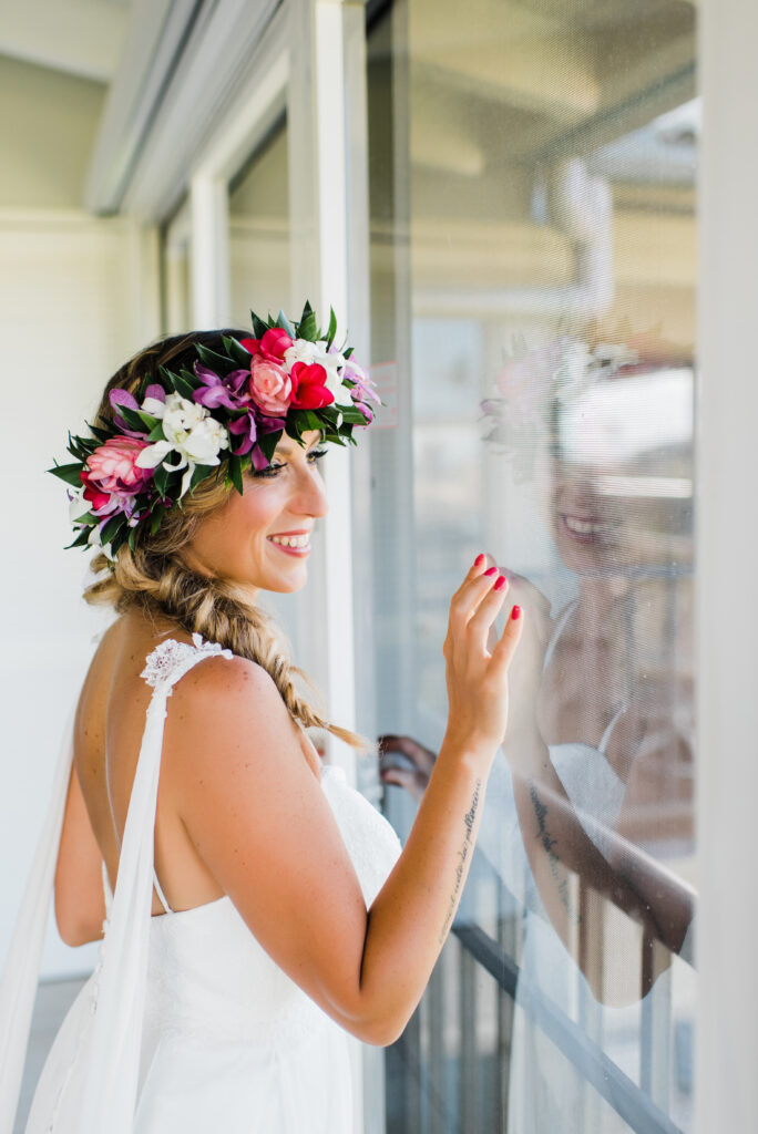 Bride wearing a colorful Hawaiian flower crown during her Maui elopement preparations.