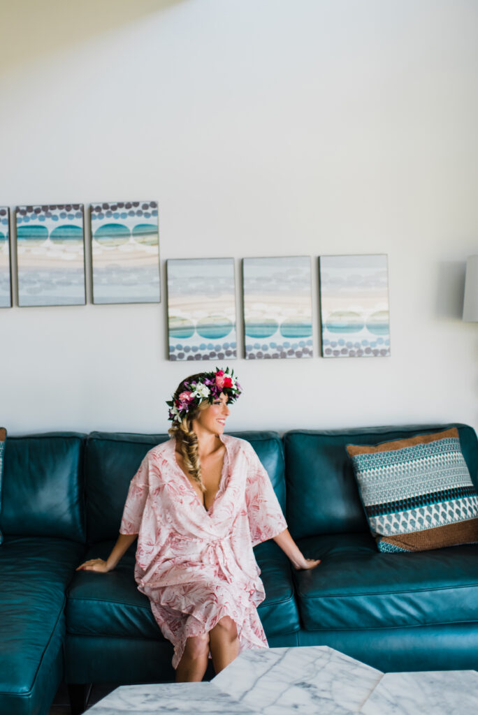 Bride wearing a tropical flower crown while relaxing before her Maui elopement ceremony.