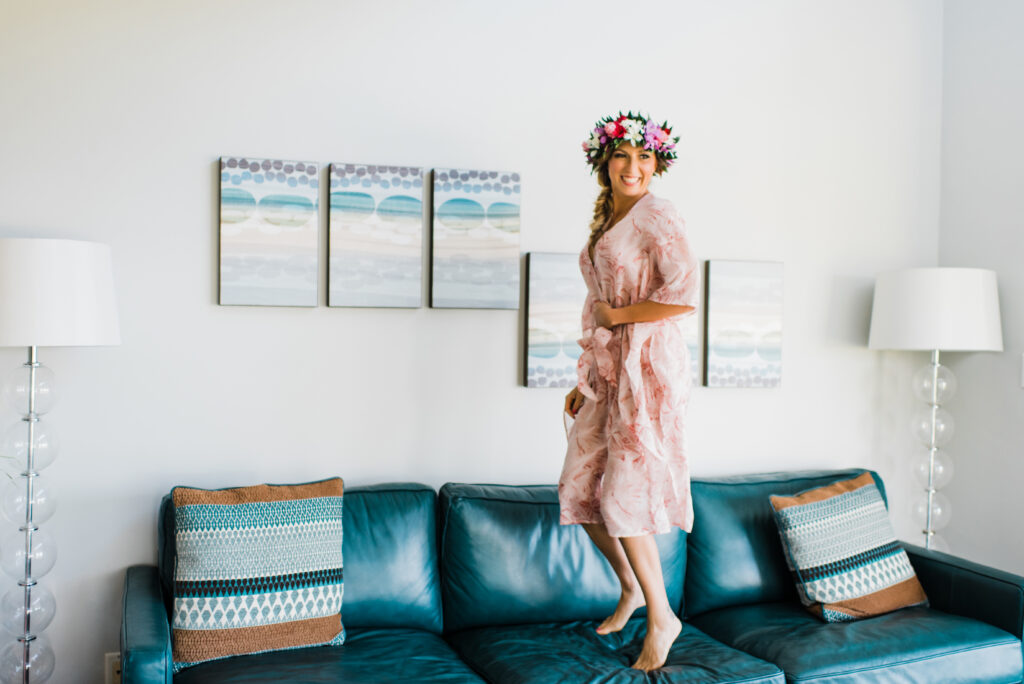 Bride smiling and enjoying the getting-ready process before her Maui elopement.