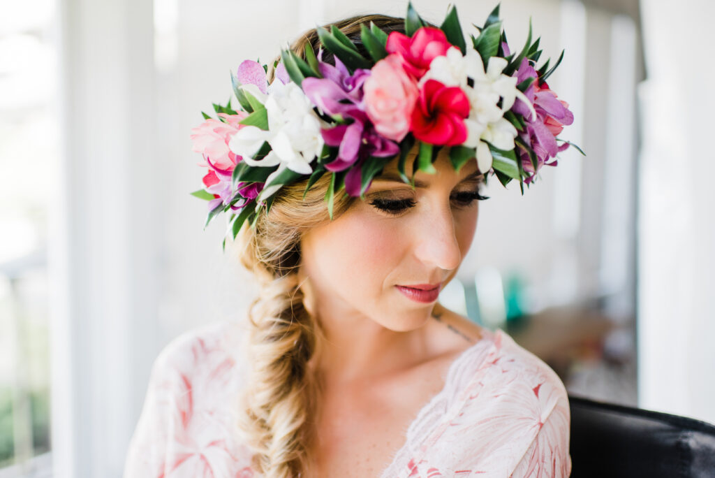 Bride wearing a tropical flower crown while getting ready for a Maui elopement ceremony.